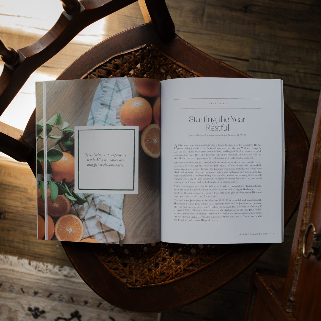 Fresh Start Bible study opened to the Starling the Year Restful page on a woven chair