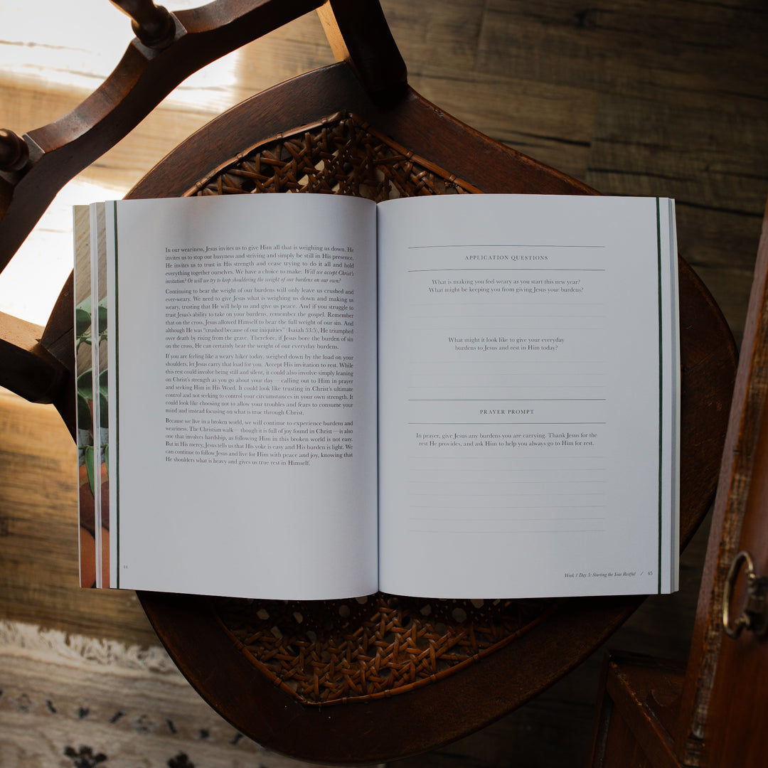 Fresh Start Bible study opened to the application and questions page on a woven chair