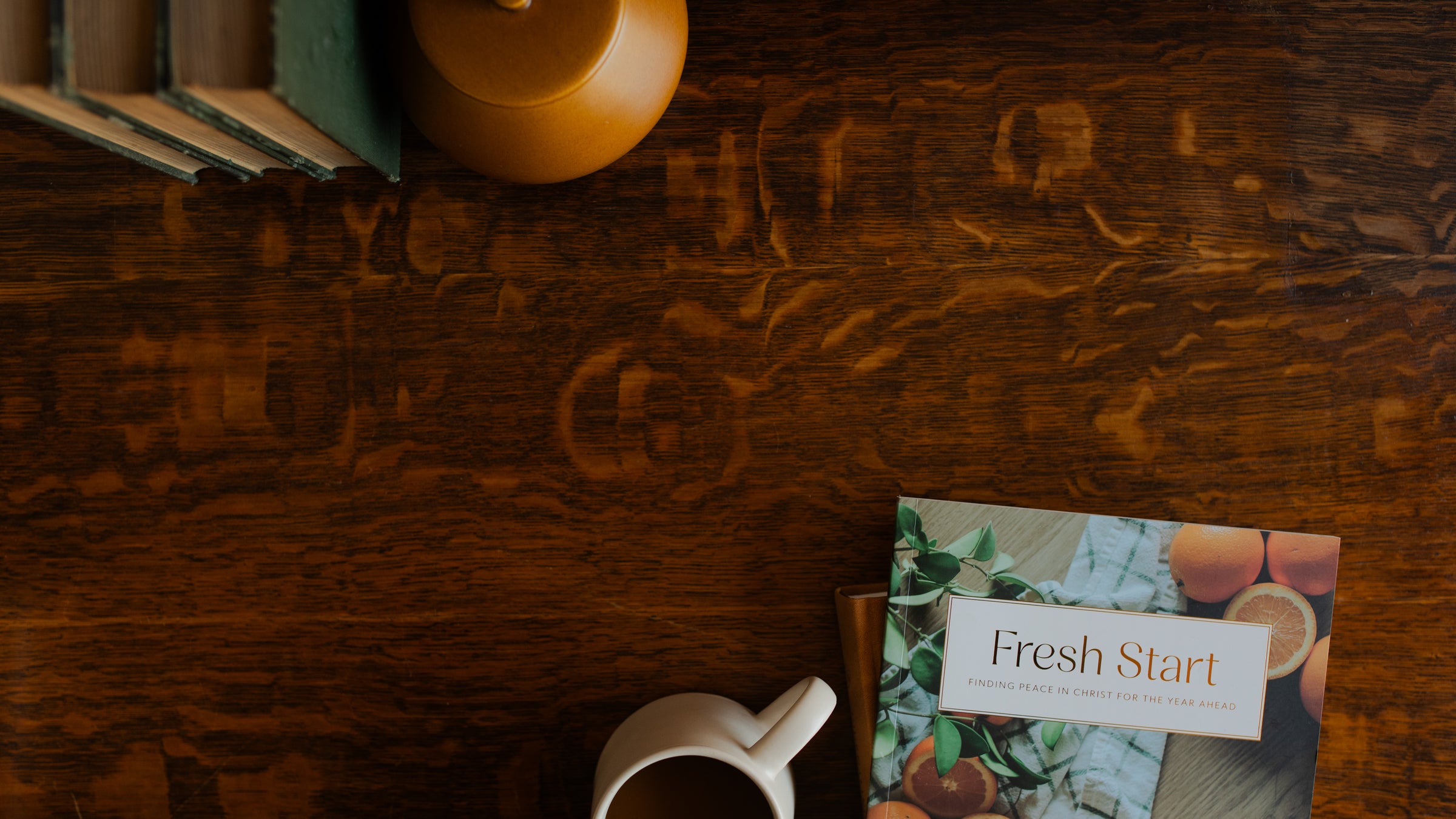 The Fresh Start study on a wooden table near a white coffee cup