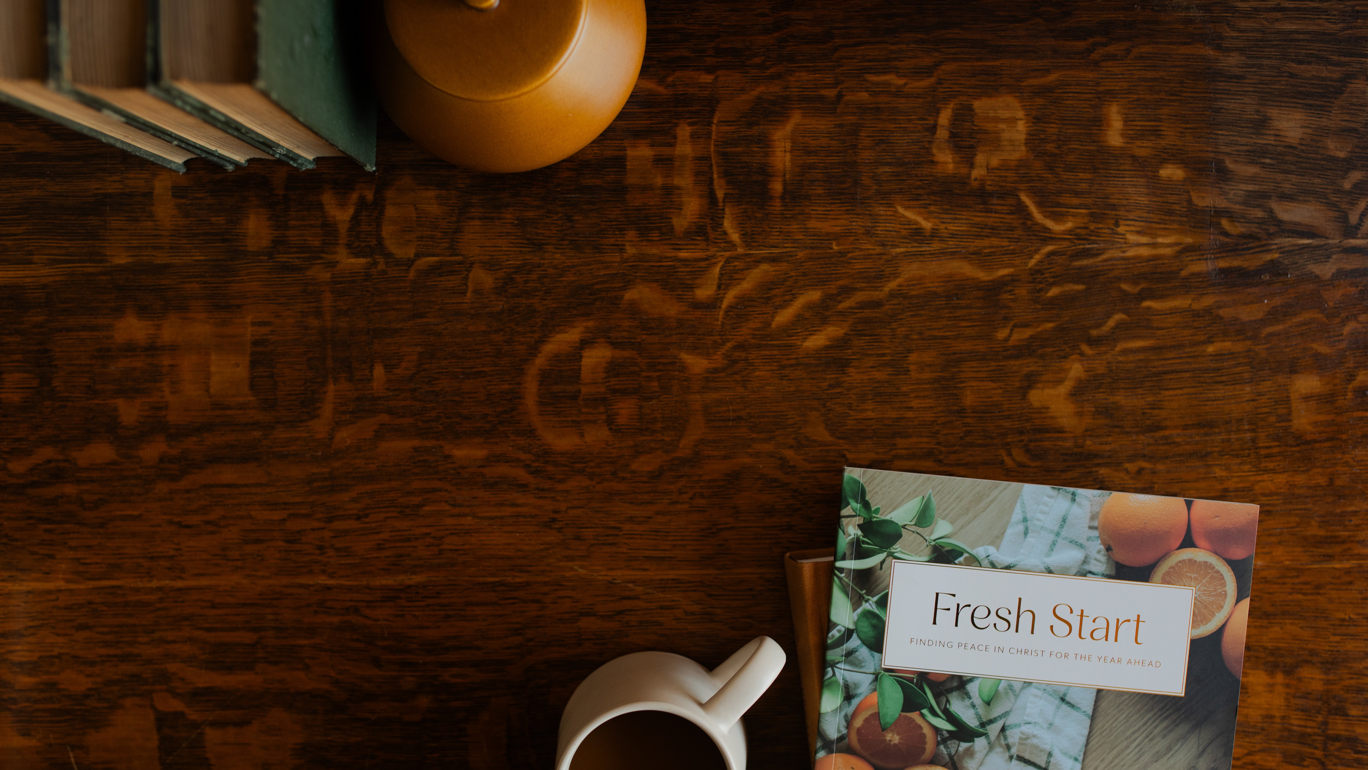 The Fresh Start study on a wooden table near a white coffee cup