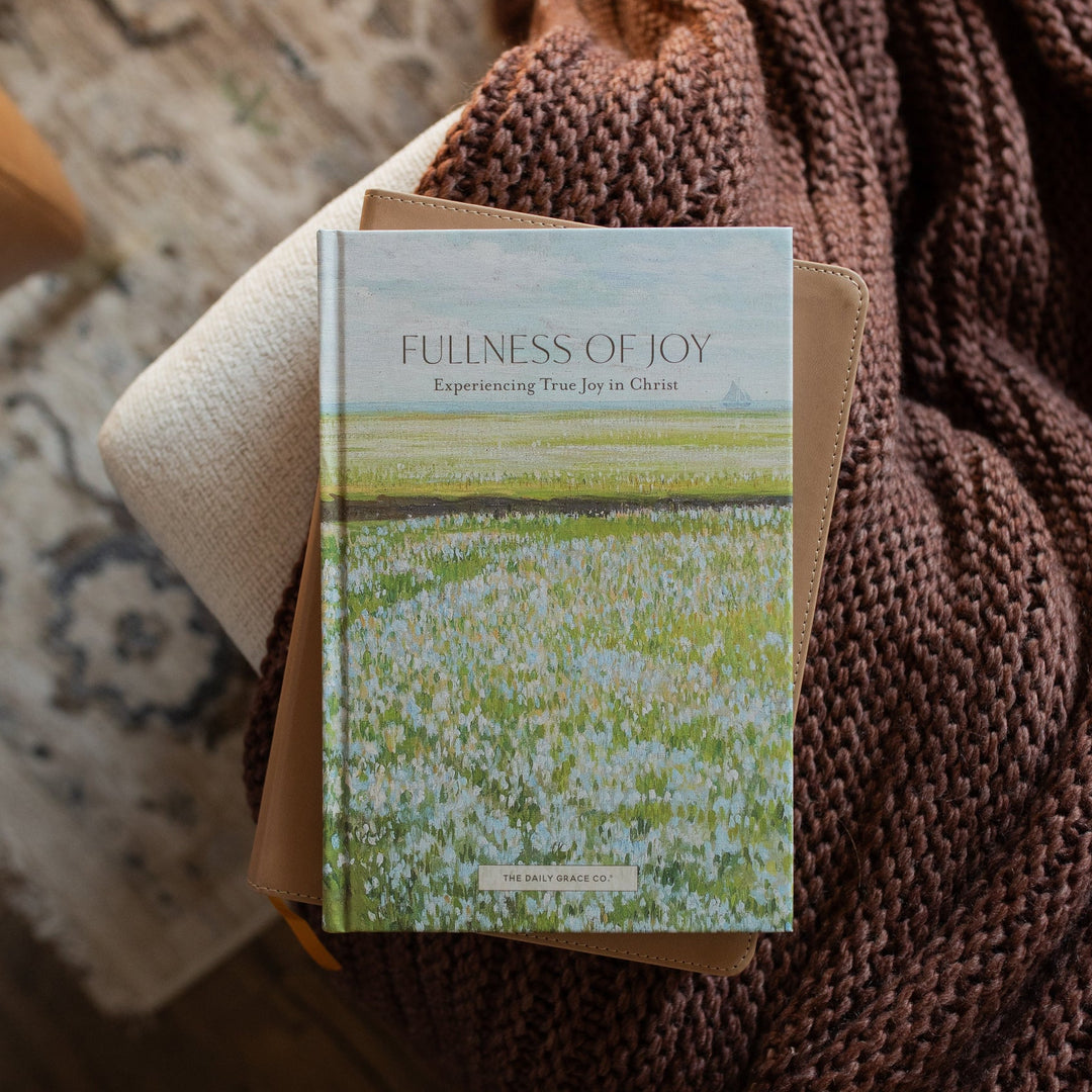 The Fullness of Joy Cover on a closed bible on a knitted blanket
