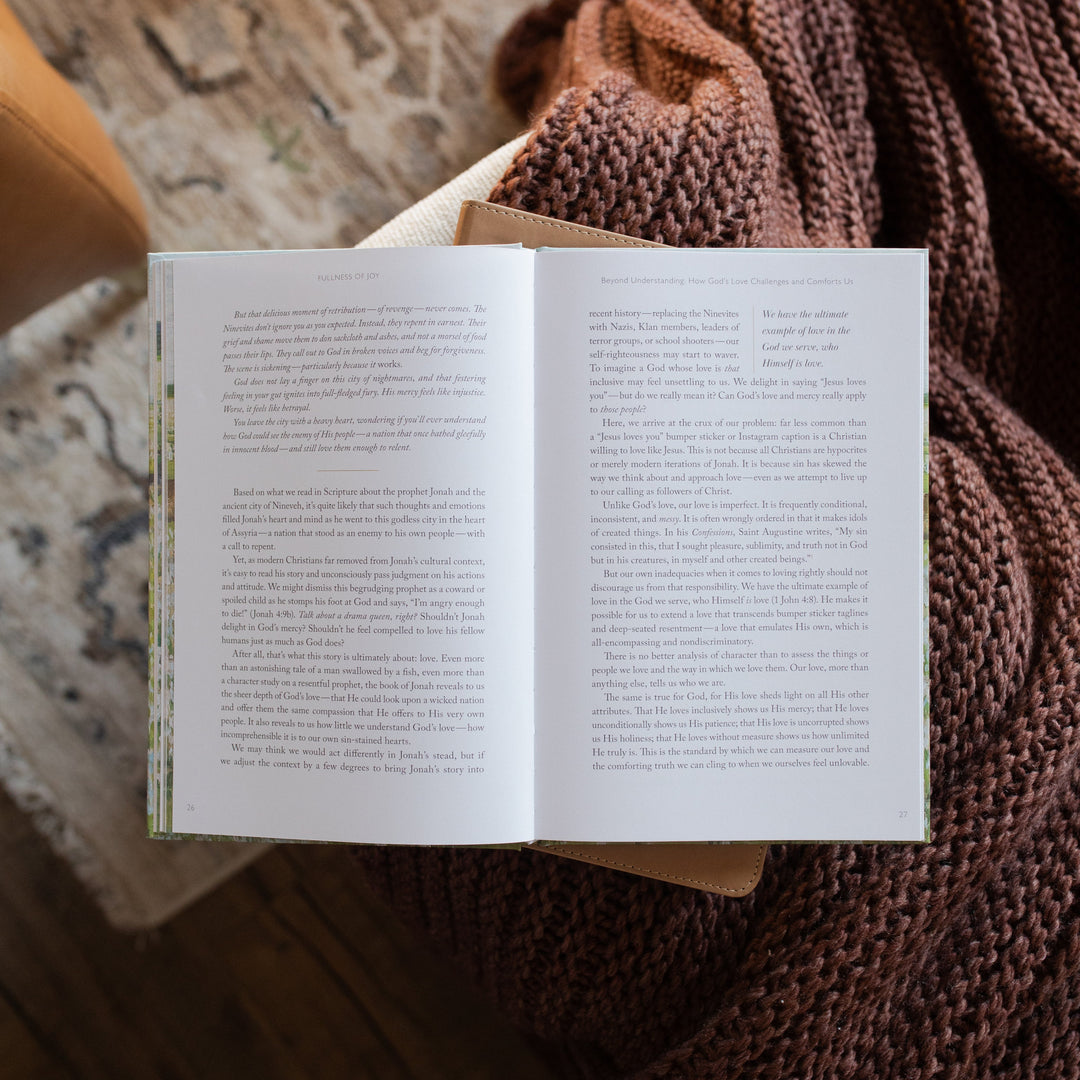 The Fullness of Joy opened to the full page reading on a closed bible on a knitted blanket