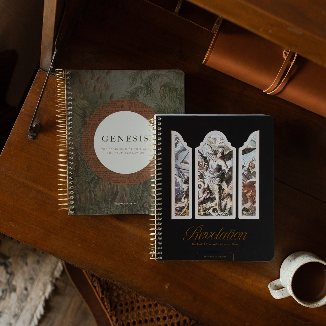 Genesis Spiral and the Revelation Spiral next to each other on a wooden table near a coffee cup