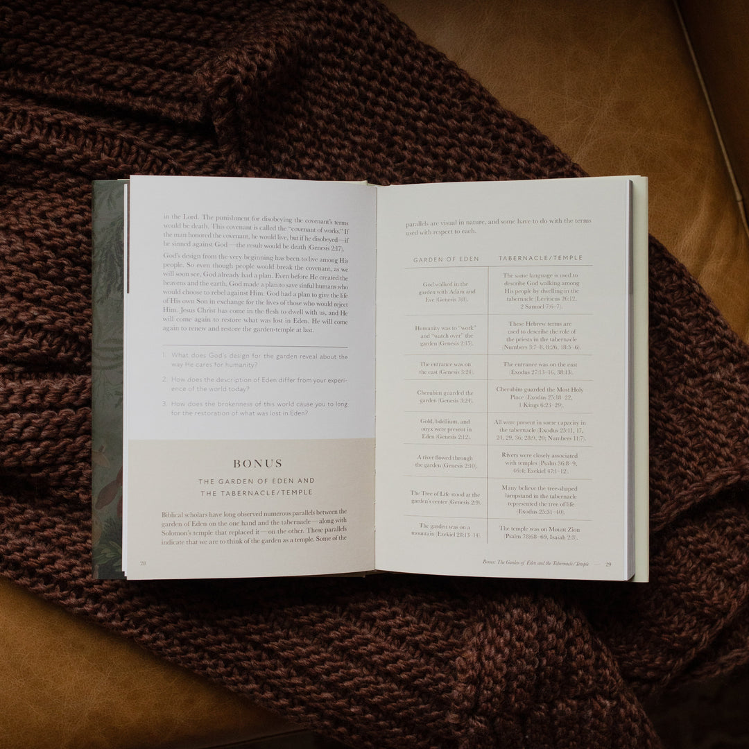Genesis Hardcover study opened to the bonus page on a woven blanket on a leather couch