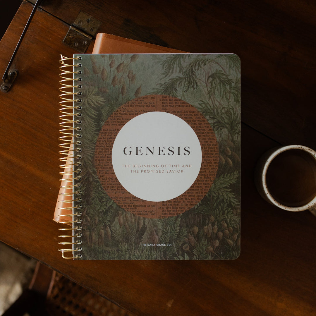 Genesis Spiral on a closed bible on a wooden table near a coffee cup