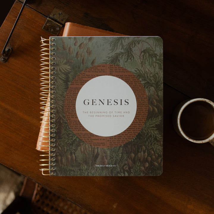 Genesis Spiral on a closed bible on a wooden table near a coffee cup