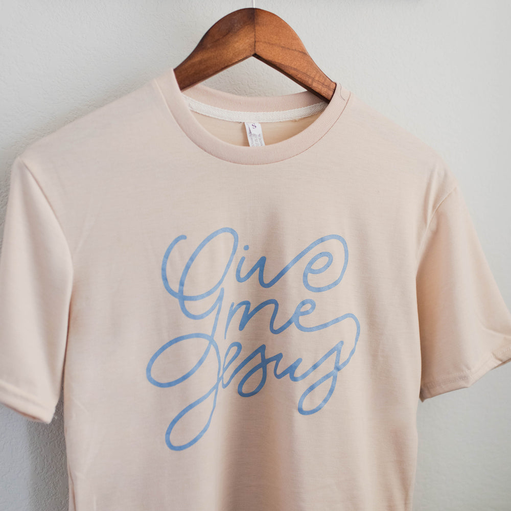 Christian apparel tee with blue cursive Give Me Jesus print on cream shirt