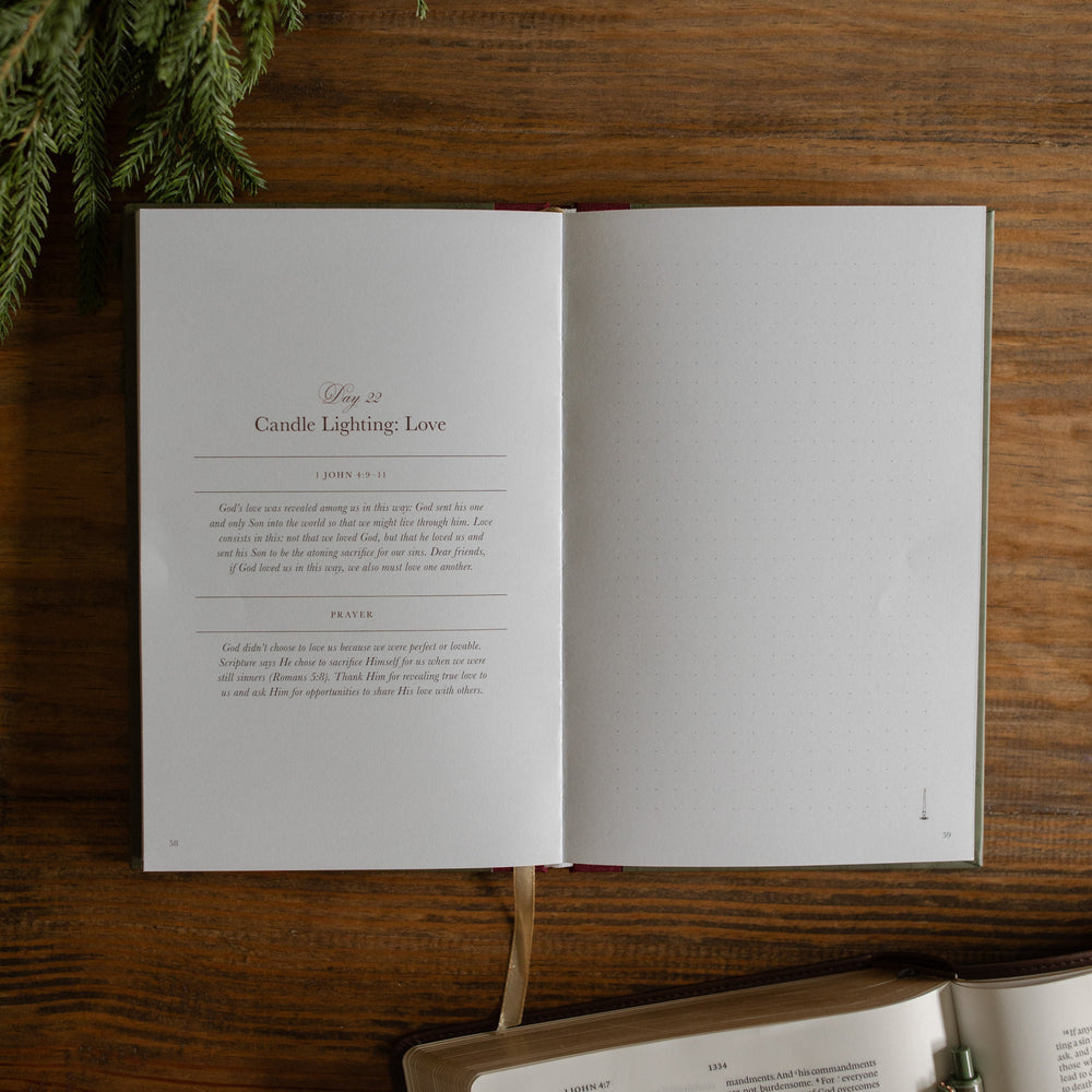 God with Us Prayer Journal open to the day 22 page on a wooden desk next to some greenery and an open bible