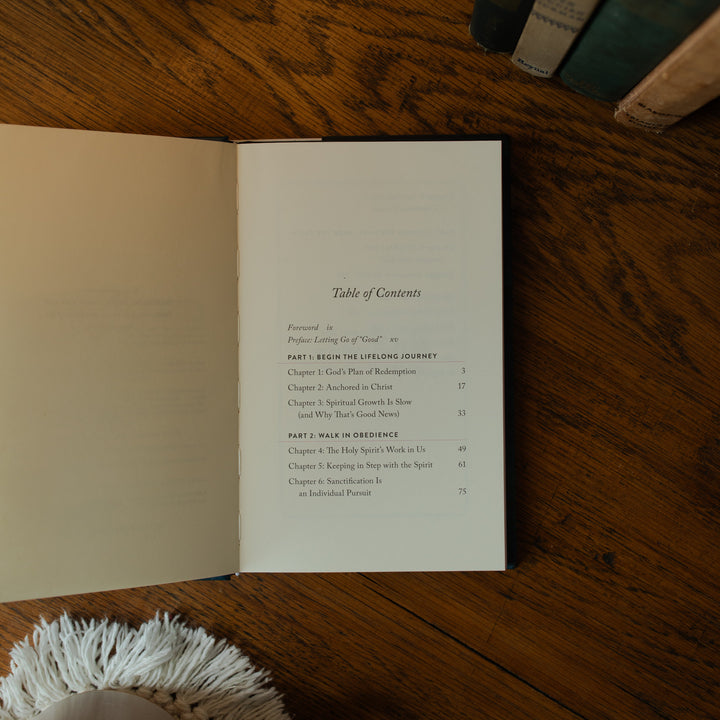 The Good Christian Girl Book opened to the table of contents page on a wooden table