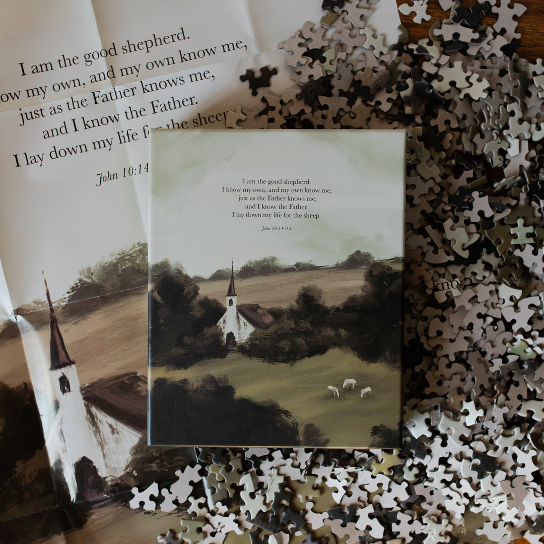 Good Shepherd Puzzle box on multiple pieces and next to the puzzle poster