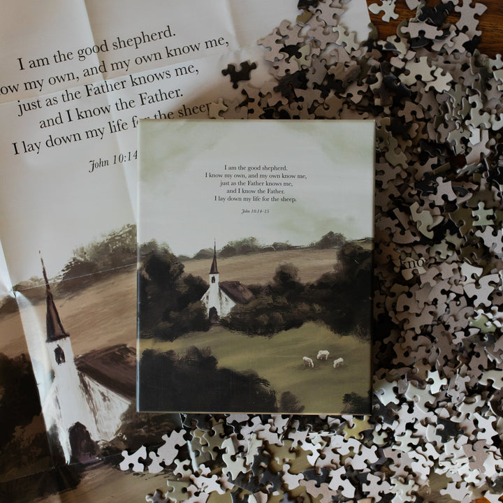 Good Shepherd Puzzle box on multiple pieces and next to the puzzle poster
