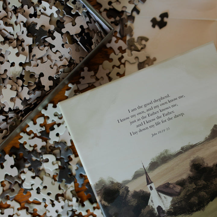 Up close of the Good Shepherd Puzzle box laying on multiple pieces