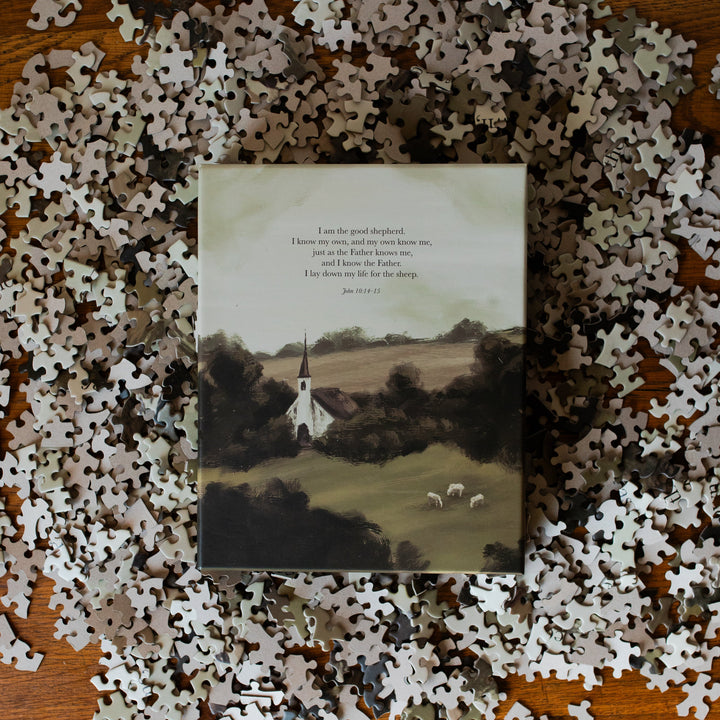 Good Shepherd Puzzle box laying in the middle of multiple pieces