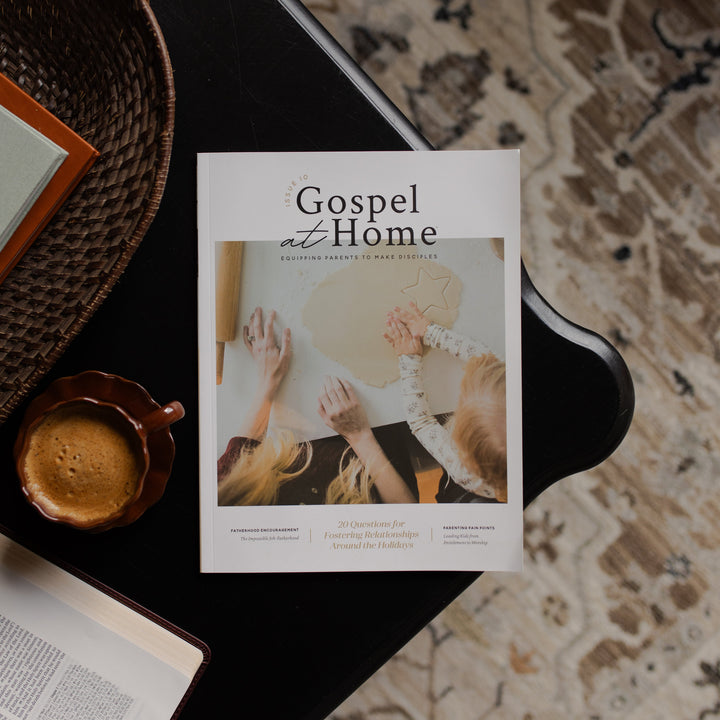 Gospel at Home Issue 10 cover on a black table near a coffee cup