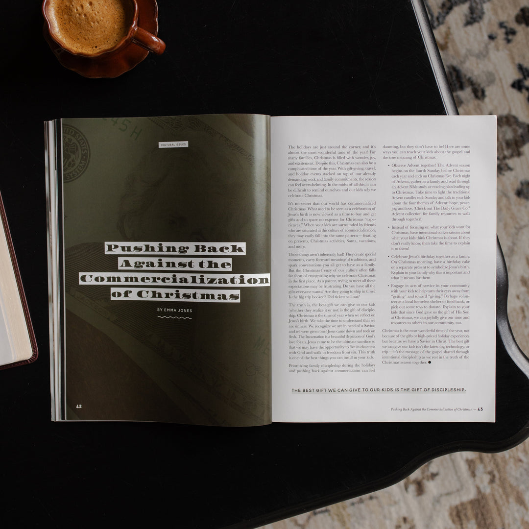 Gospel at Home Issue 10 opened to the Pushing back against commercialization of Christmas page on a black table near a coffee cup