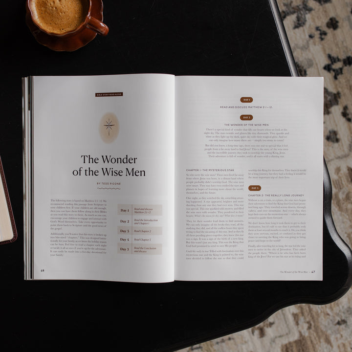 Gospel at Home Issue 10 opened to the the Wonder of the Wise Men page on a black table near a coffee cup