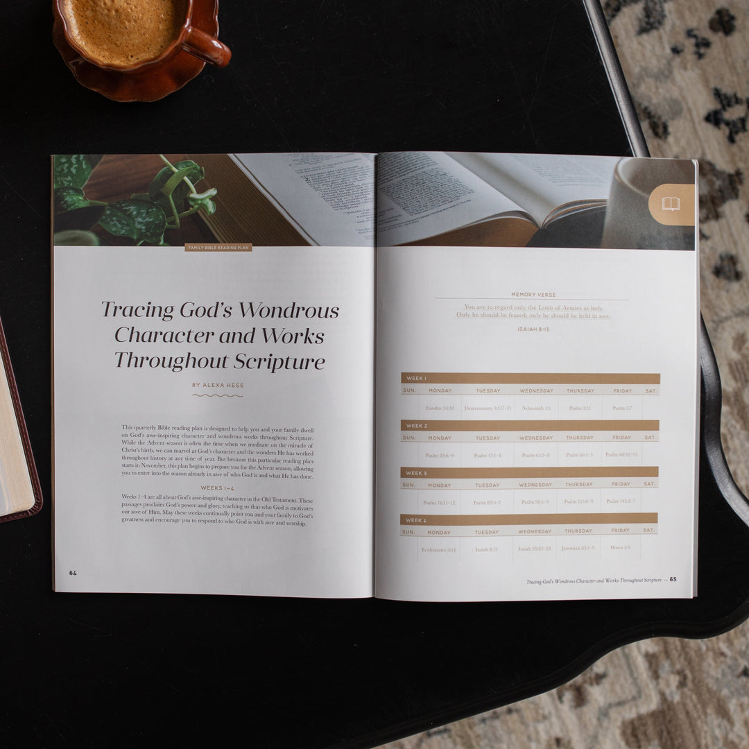 Gospel at Home Issue 10 opened to the tracing God's Wondrous character and works throughout scripture page on a black table near a coffee cup