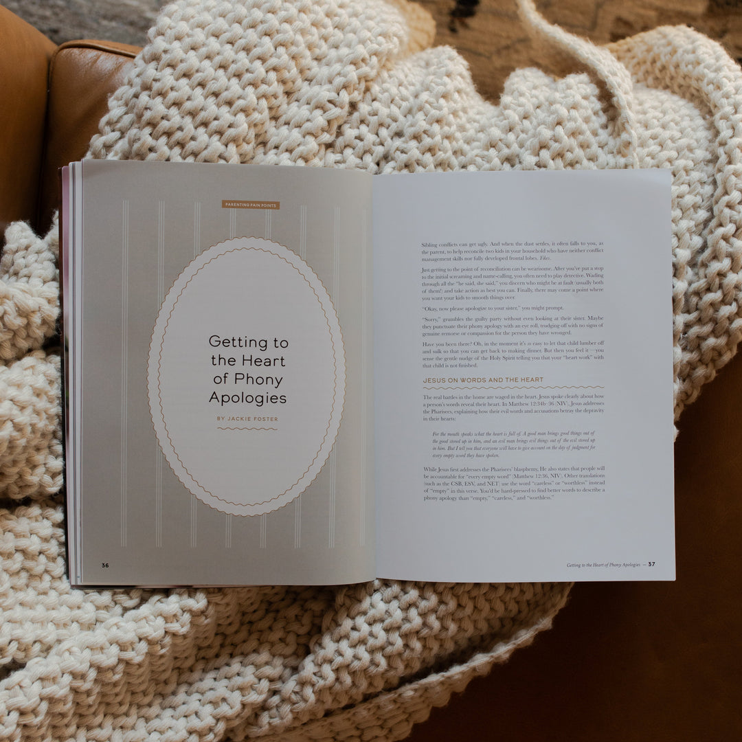 Gospel at Home Issue 11 opened to the Getting to the Heart of Phony Apologies page on a white knitted blanket