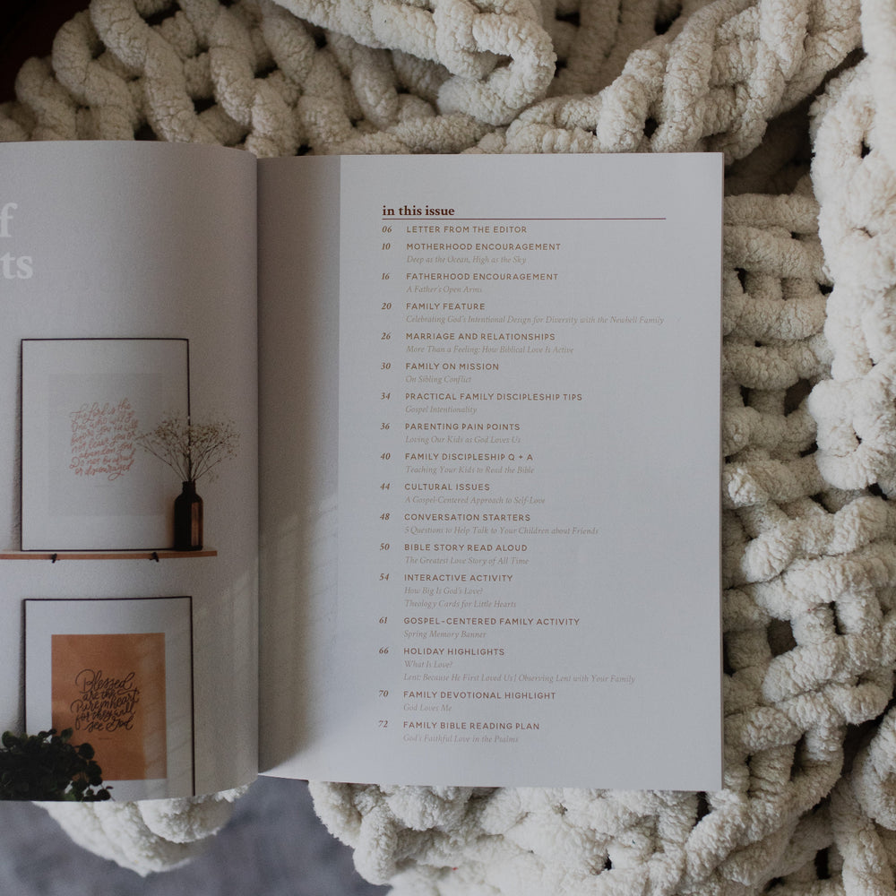 Gospel at Home Issue 7 opened to the table of contents page on a white knitted blanket