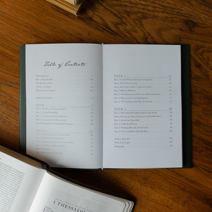 Open book with table of contents on a wooden surface