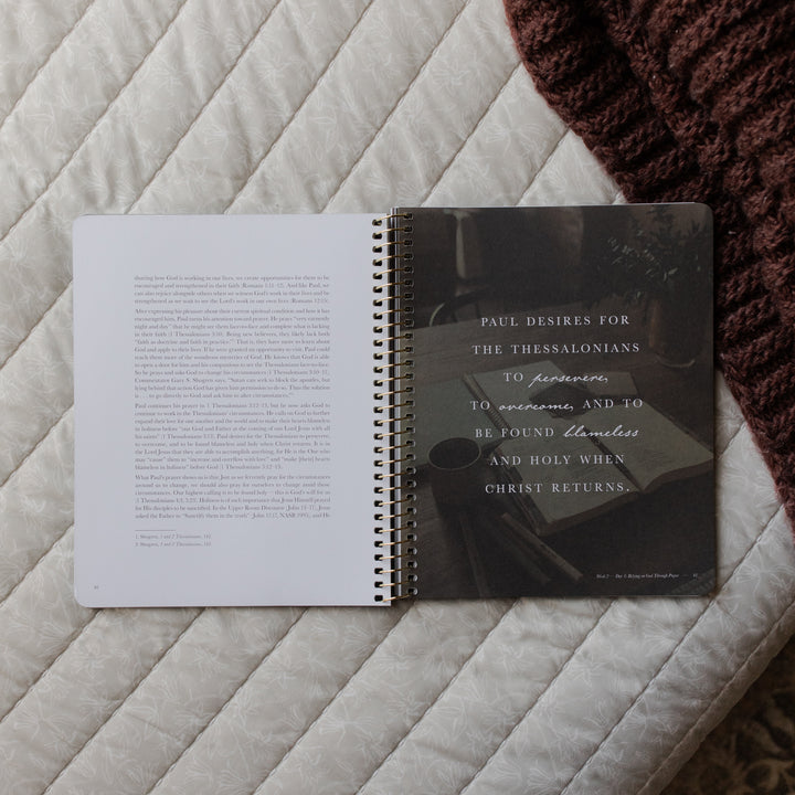 Open book with text on a textured surface