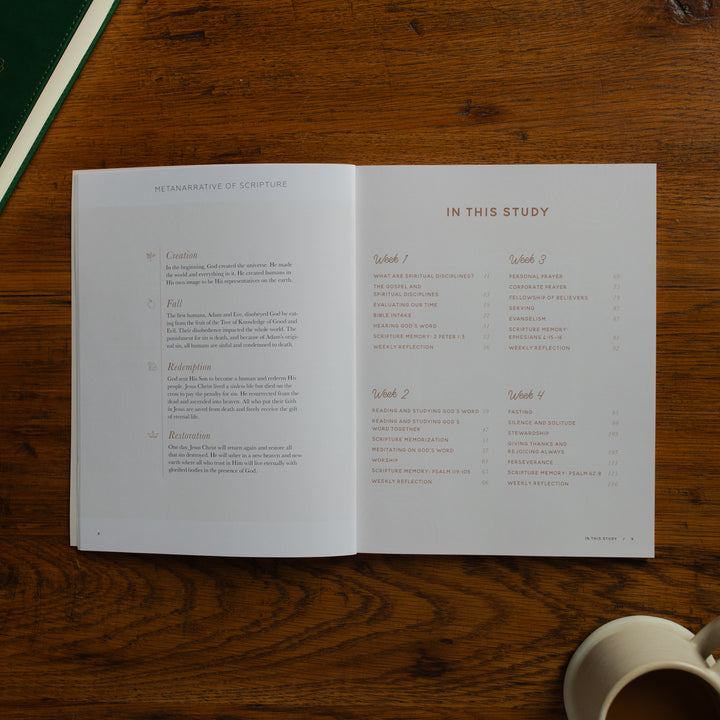 Open book on a wooden surface with a cup of coffee
