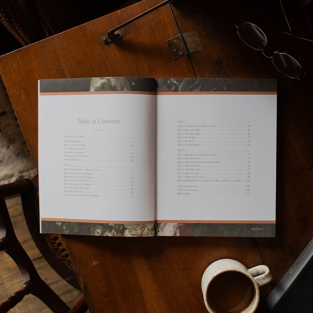 Haggai study opened to the table of contents page on a wooden desk near a pair of eyeglasses