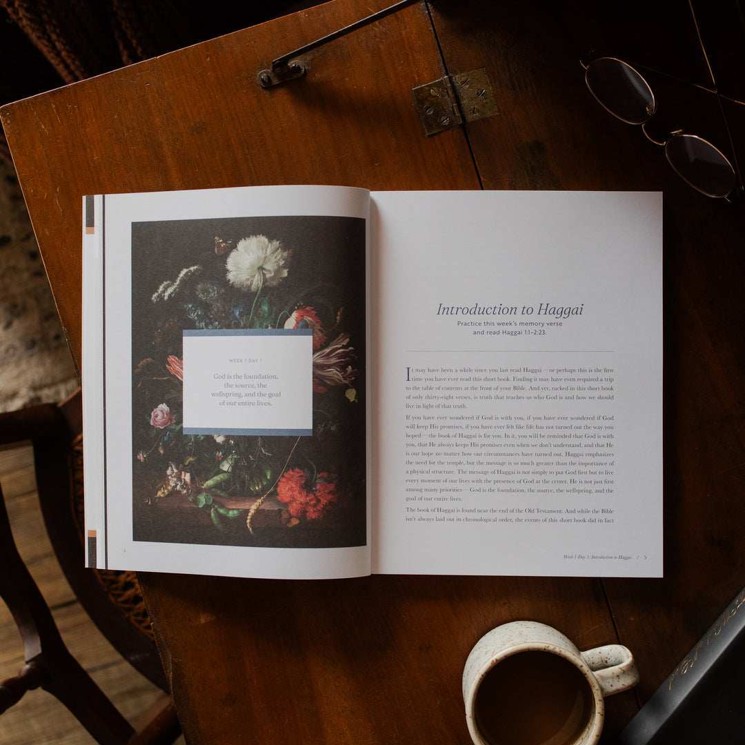 Haggai study opened to the introduction to Haggai page on a wooden desk near a pair of eyeglasses