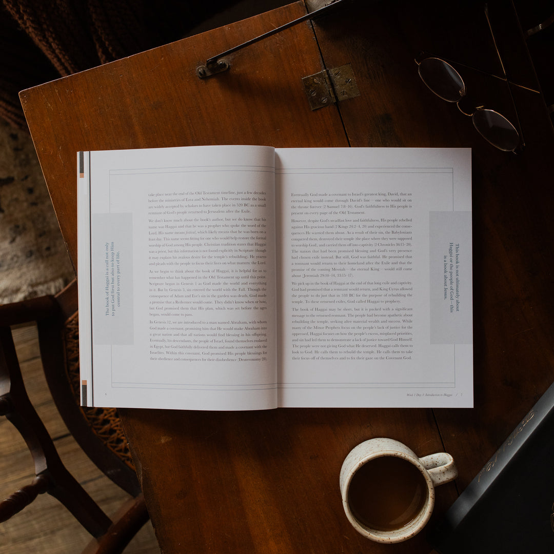 Haggai study opened to the week 1 day 1 page on a wooden desk near a pair of eyeglasses