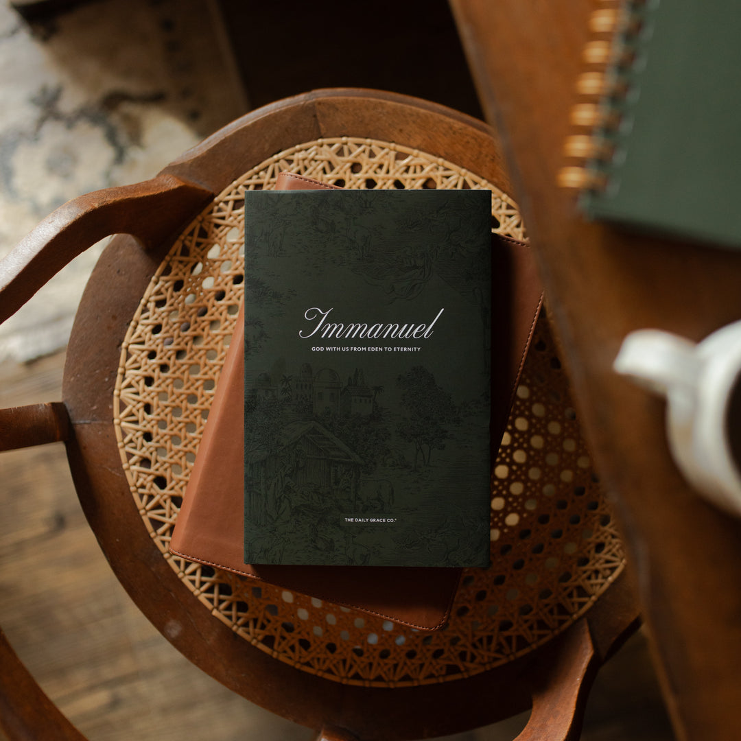 The Immanuel Hardcover cover on a closed bible on a wooden and woven chair