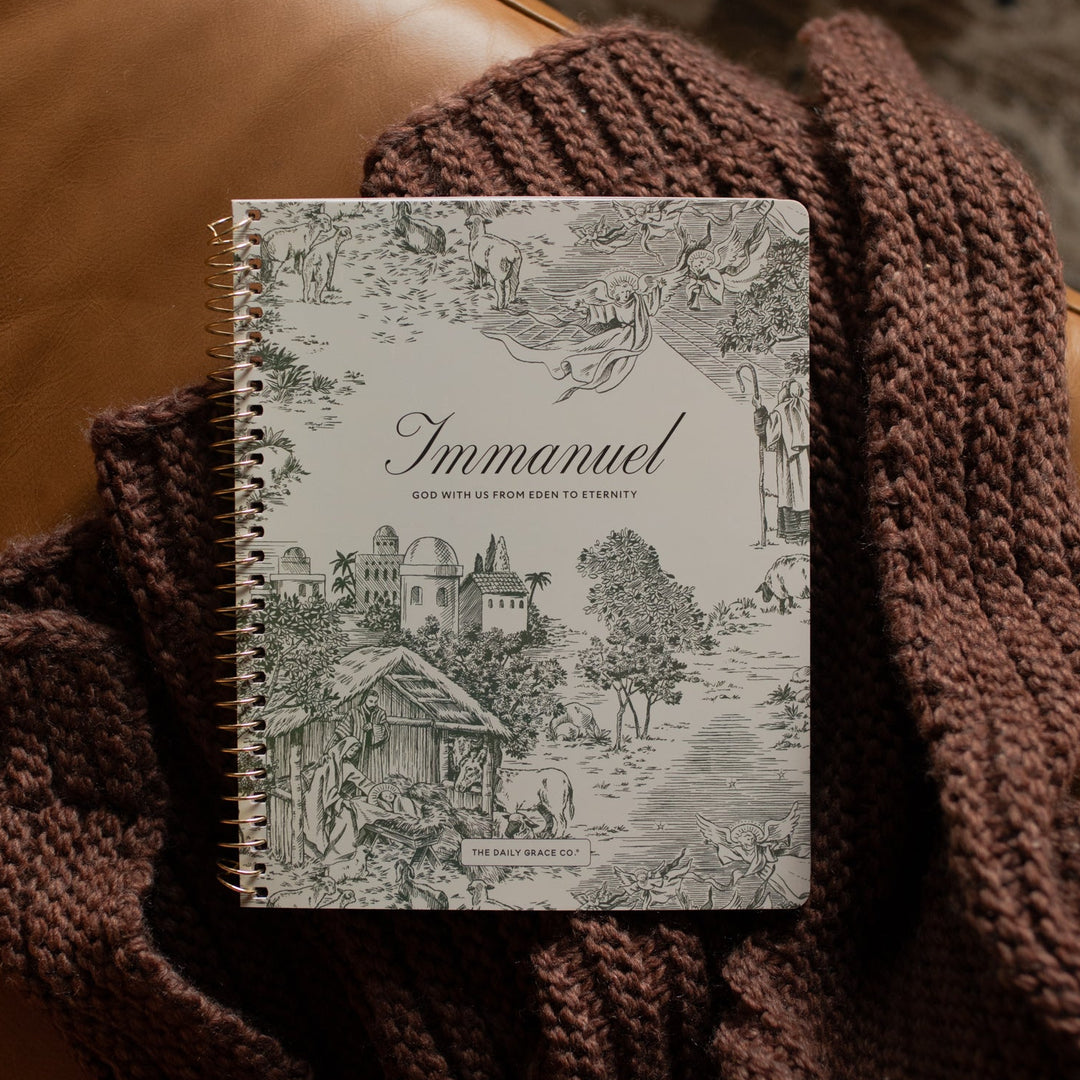 The Immanuel Spiral cover on a woven blanket on a leather couch