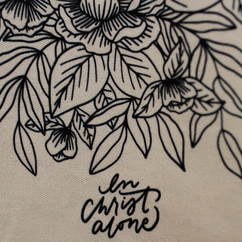 Close up of floral pattern and words in Christ alone on tea towel