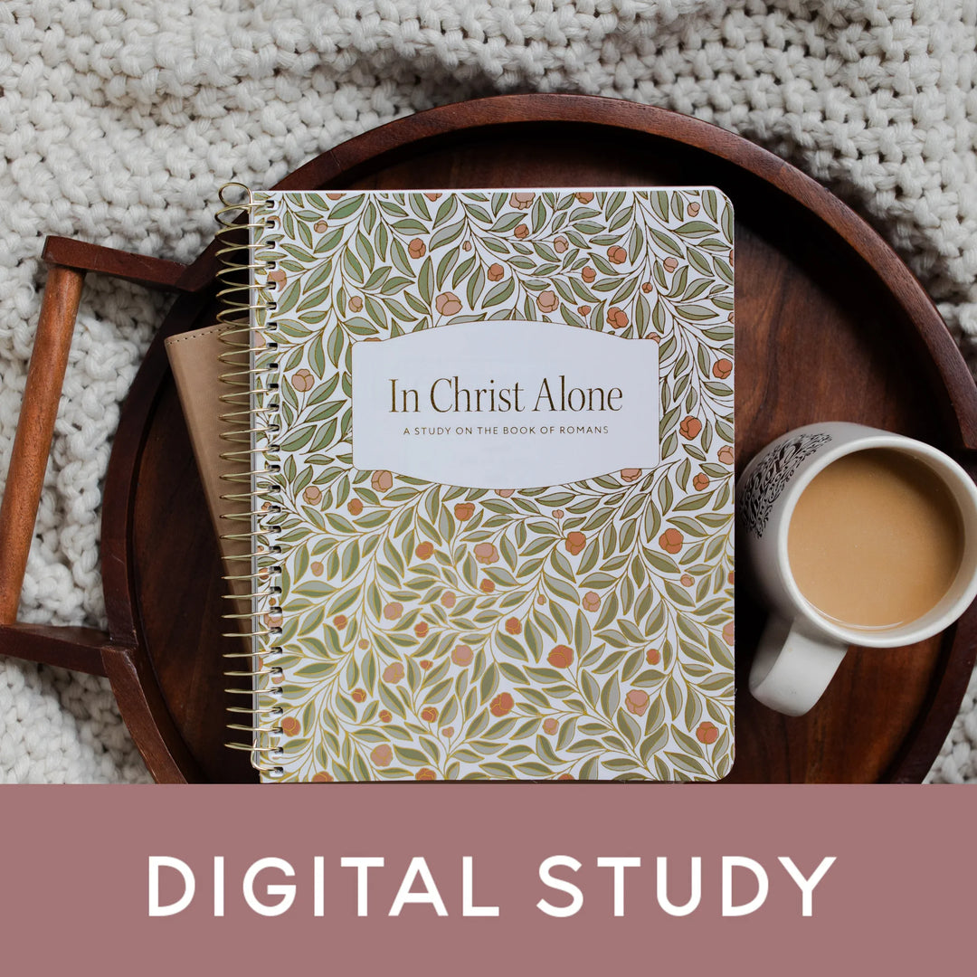 In Christ Alone Study Cover on a Bible next to a white coffee cup on a wooden tray on a knitted blanket