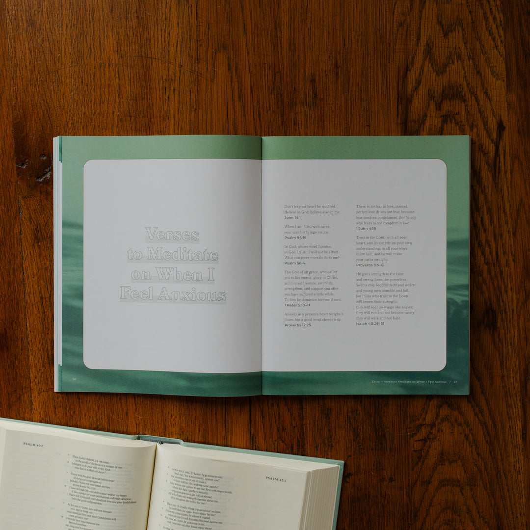 It is Well Teen Study opened to the verses to meditate on when i feel anxious page on a wooden table next to an open bible