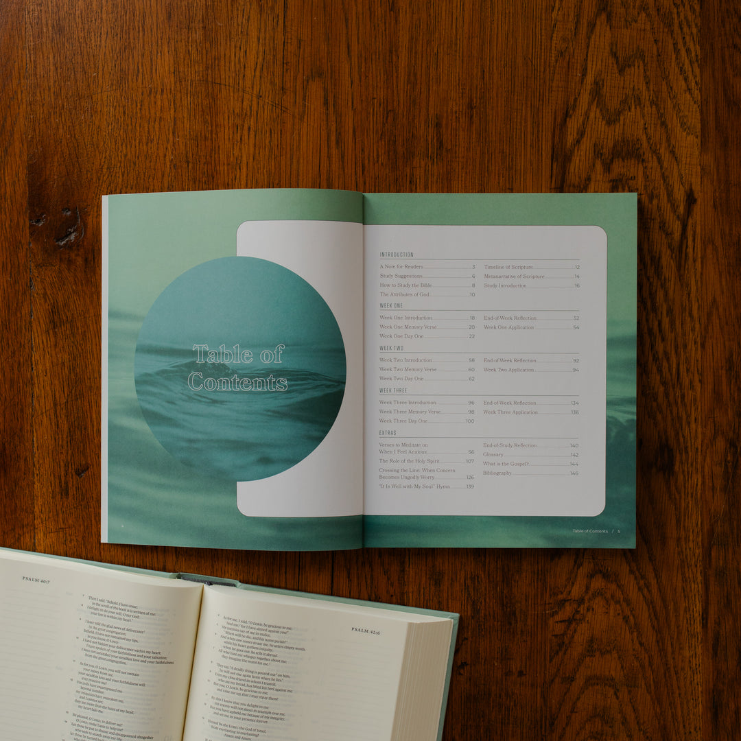 It is Well Teen Study opened to the table of contents page on a wooden table next to an open bible