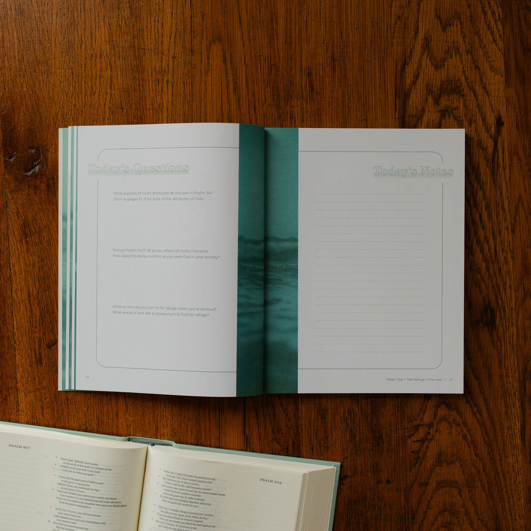 It is Well Teen Study opened to the questions and notes page on a wooden table next to an open bible