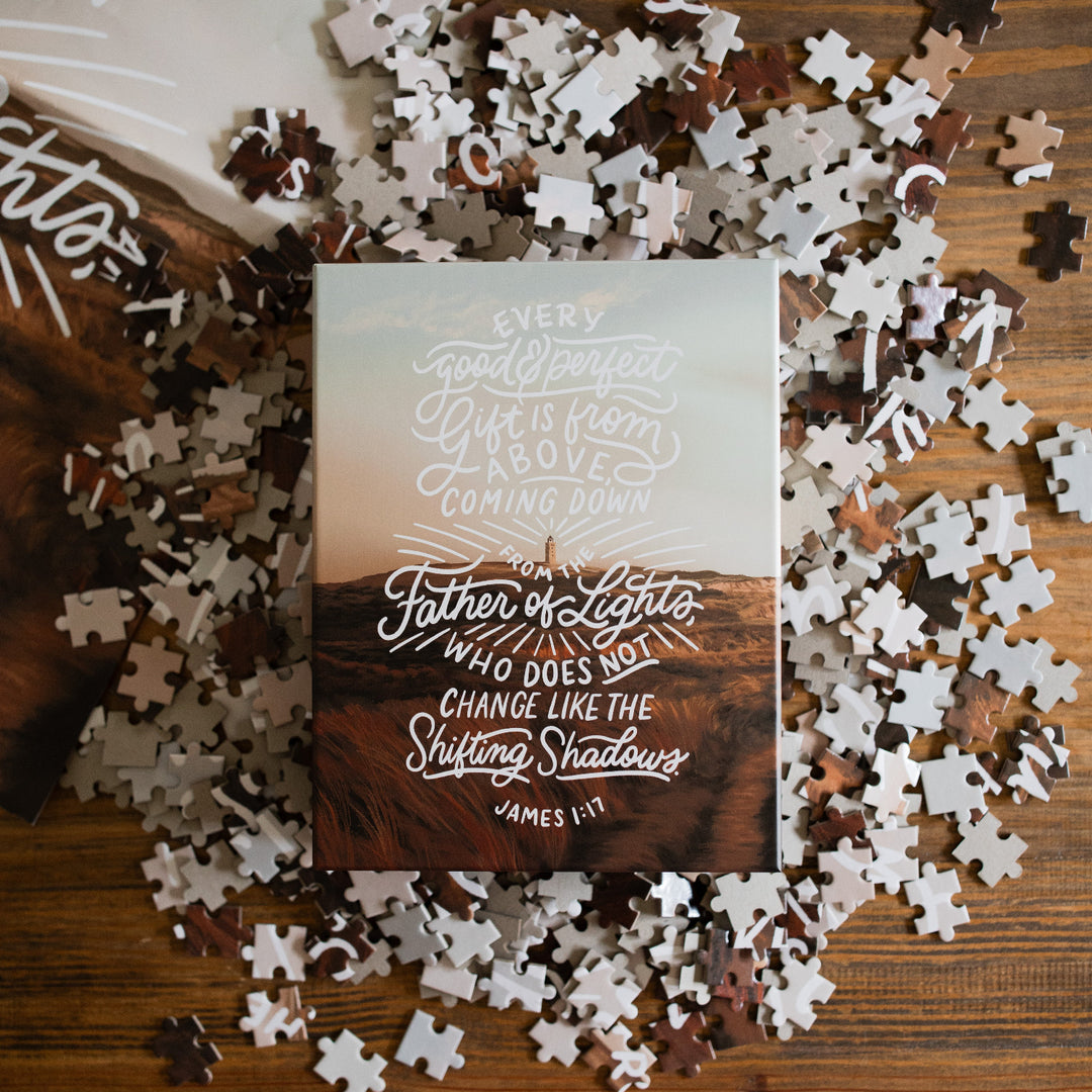 James Puzzle spread out over a brown table with the puzzle box on top of the pieces