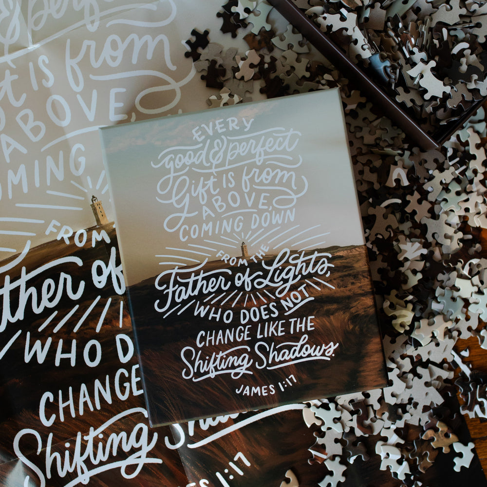 James Puzzle Box cover on a bunch of scattered puzzle pieces and the James Poster near the bottom box with multiple James Puzzle pieces in it