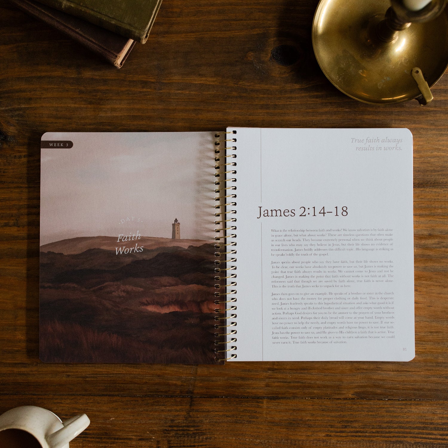 James Men's Spiral study opened to week 3 page on a brown wooden table next to a bronze oil lamp