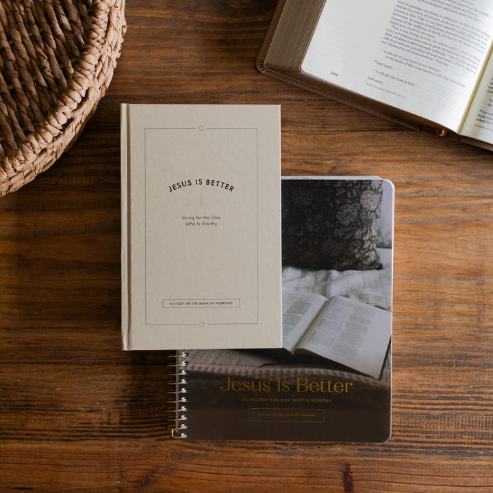 Jesus is Better Men and Women's Study cover on a wooden desk next to a woven basket and an open bible