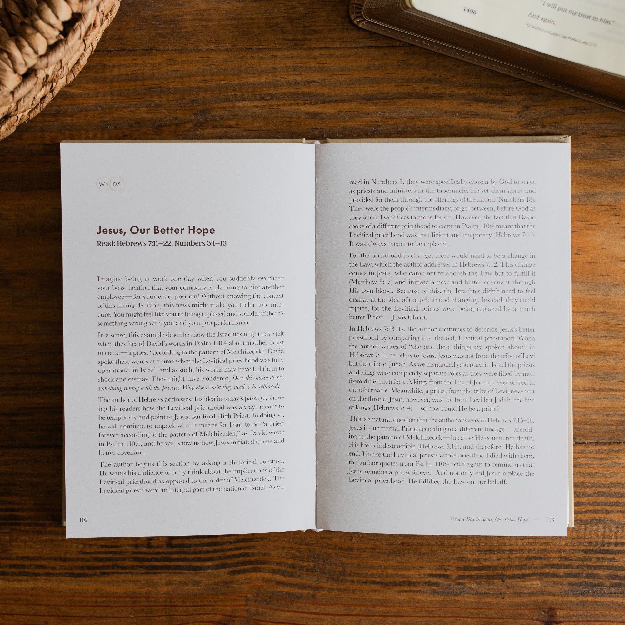 Jesus is Better Mens study opened to the Jesus, our better hope page on a wooden desk next to a woven basket and an open bible