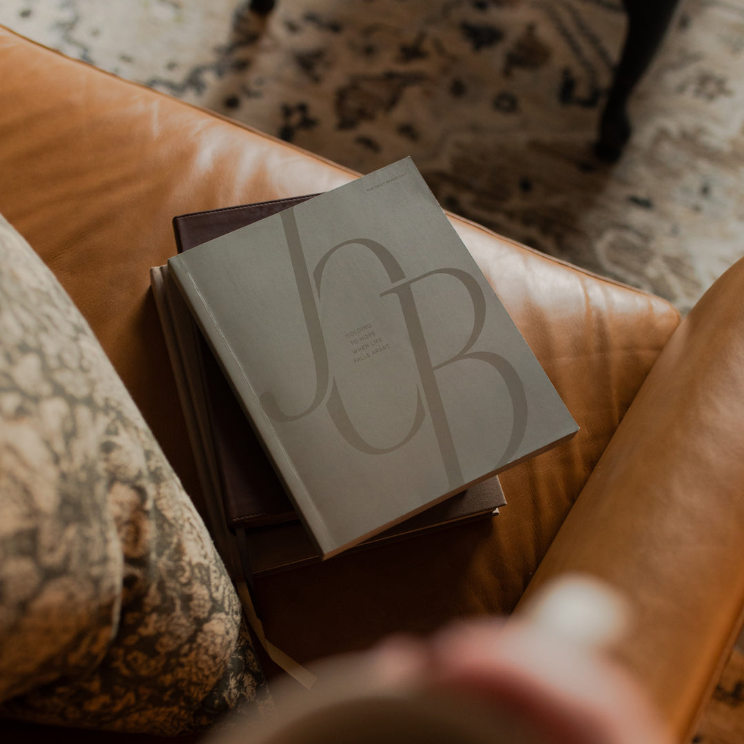 Job Softcover cover on a closed bible on a leather couch