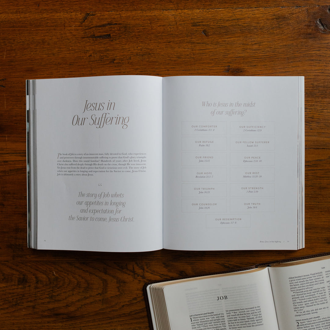 Job Softcover opened to the Jesus in our suffering page on a wooden table