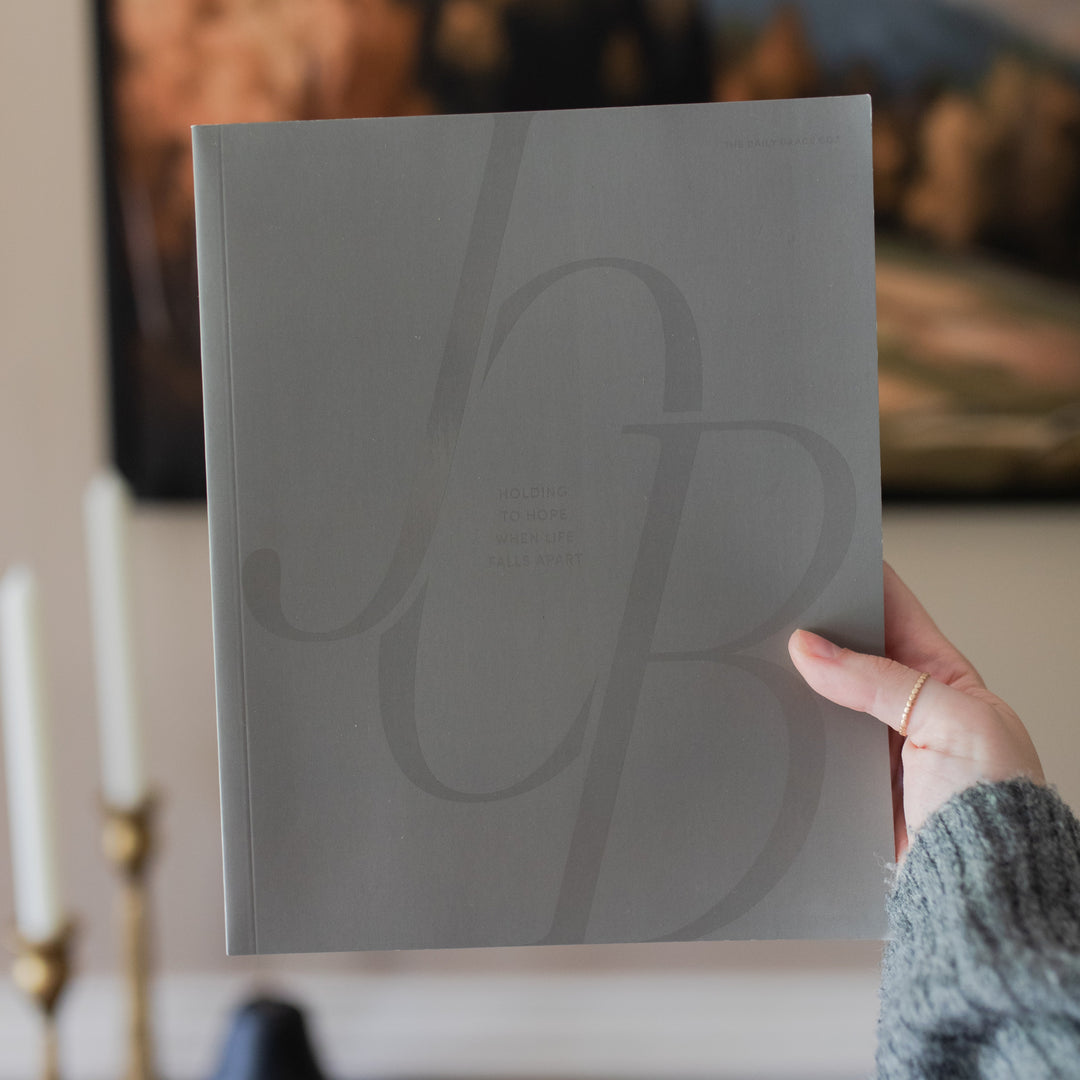 A woman's hand holding up the Job Study cover