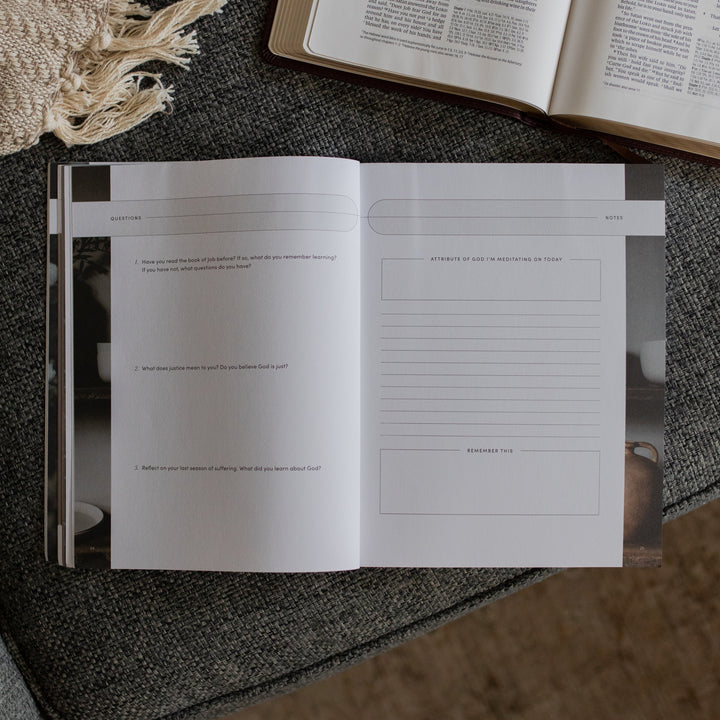 The Job study opened to the questions and notes page near an open bible on a grey couch