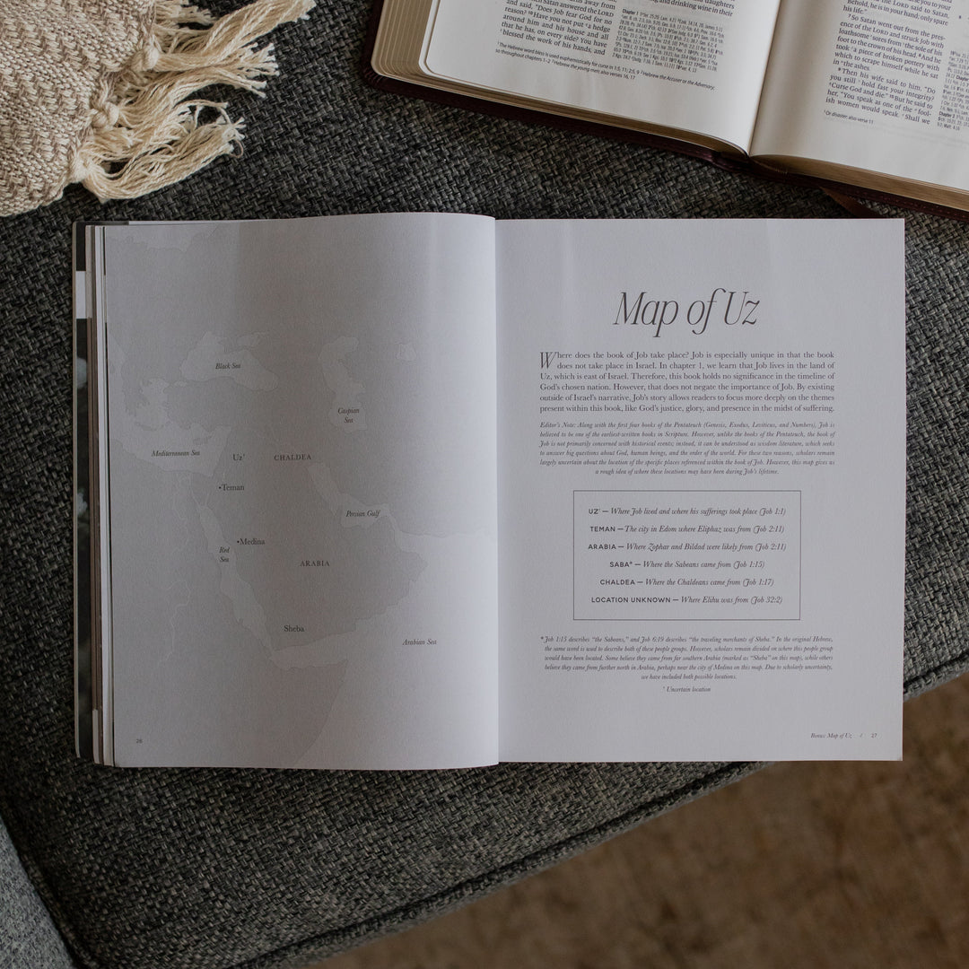The Job study opened to the Map of Uz page near an open bible on a grey couch