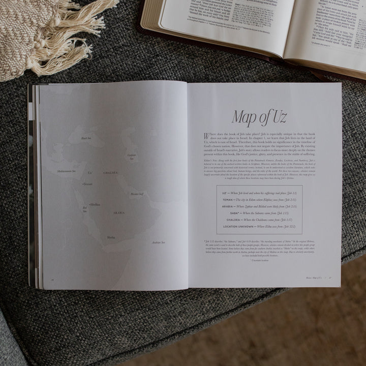 The Job study opened to the Map of Uz page near an open bible on a grey couch