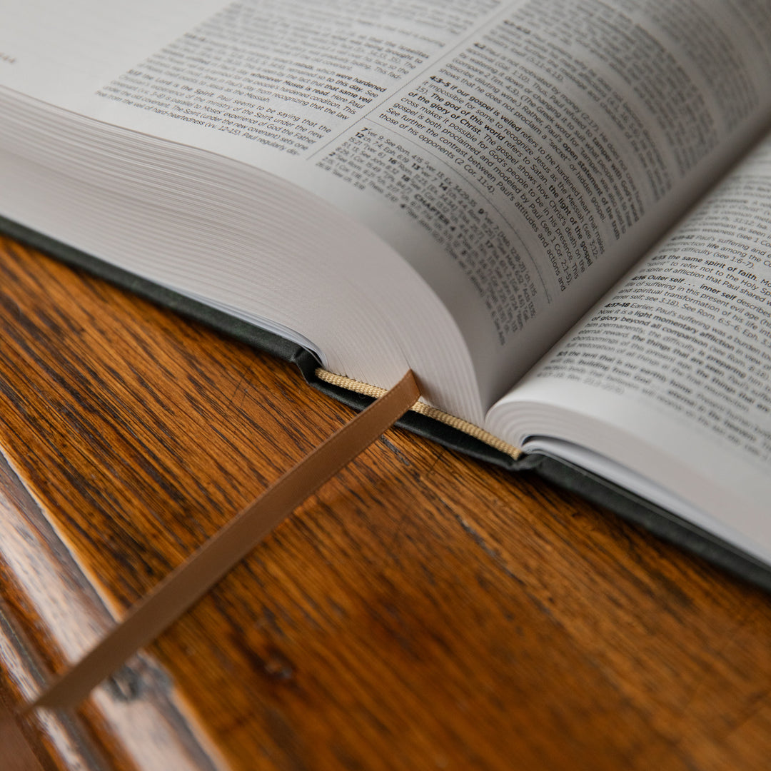 Open Bible showing the tassel on a wooden surface