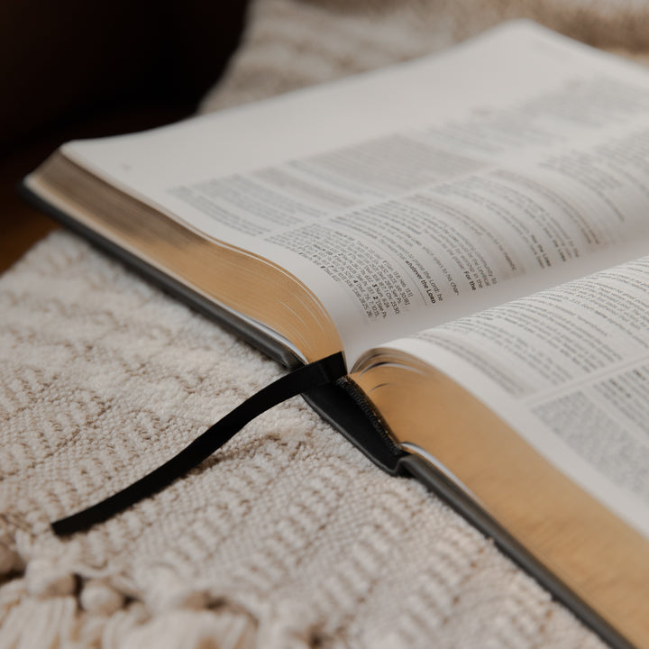 Open bible on a textured surface with a blurred background
