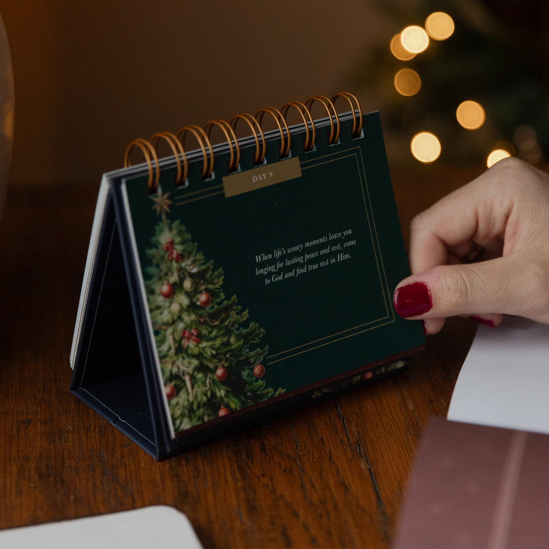 A womans hand on a flipbook resting on a table on day 9